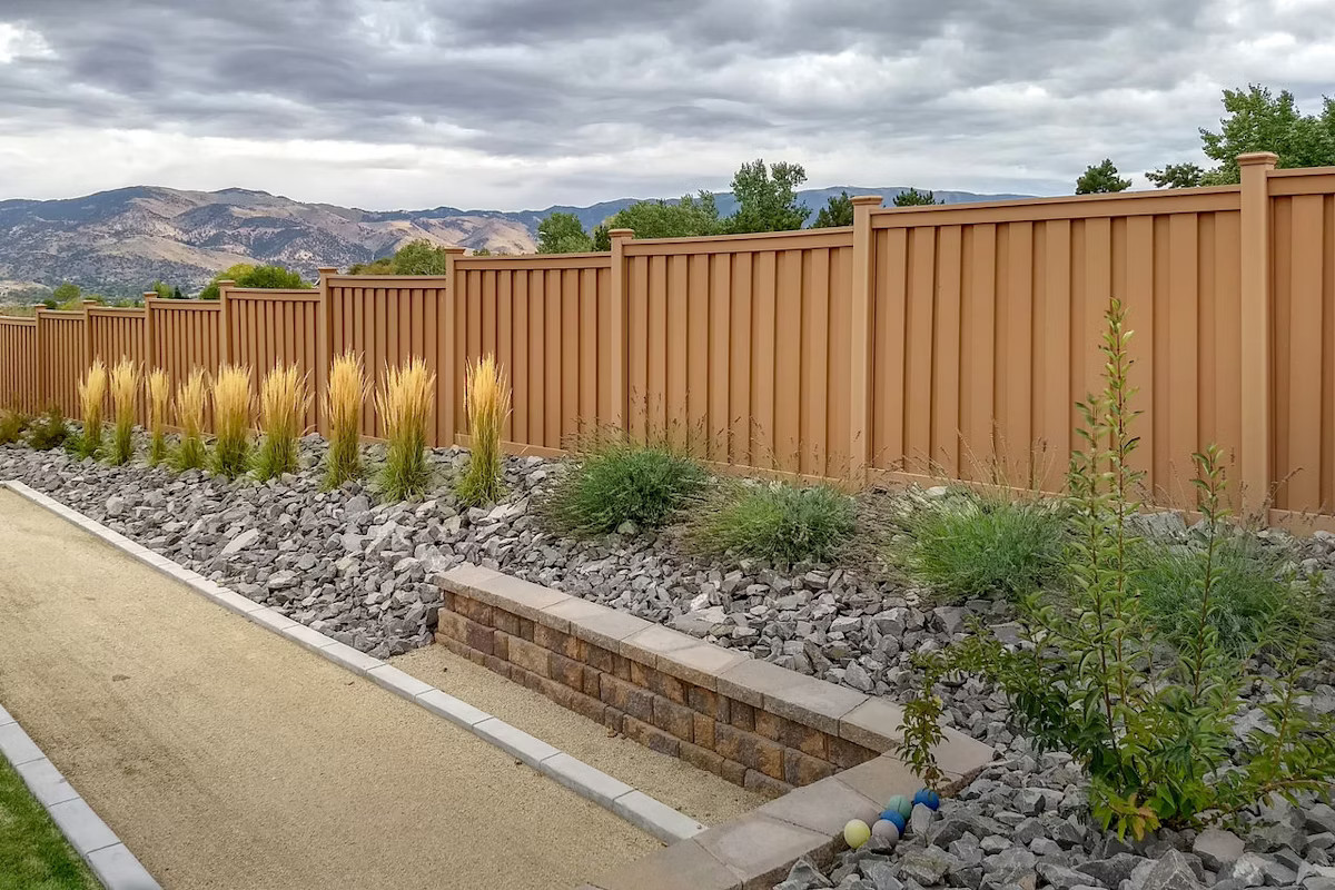 Fence With Rock Retaining Wall