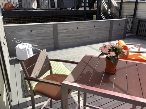 Dark Gray Patio Furniture With Metal Trim And Wooden Details In A Patio Setting