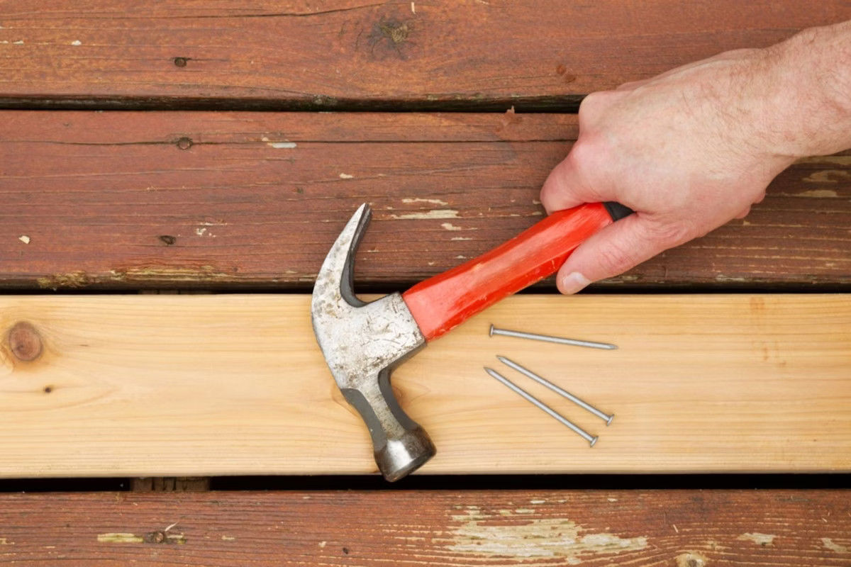 Hammer and Nails on a newly replaced Deck Board